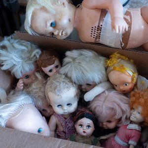 a box of vintage baby dolls
